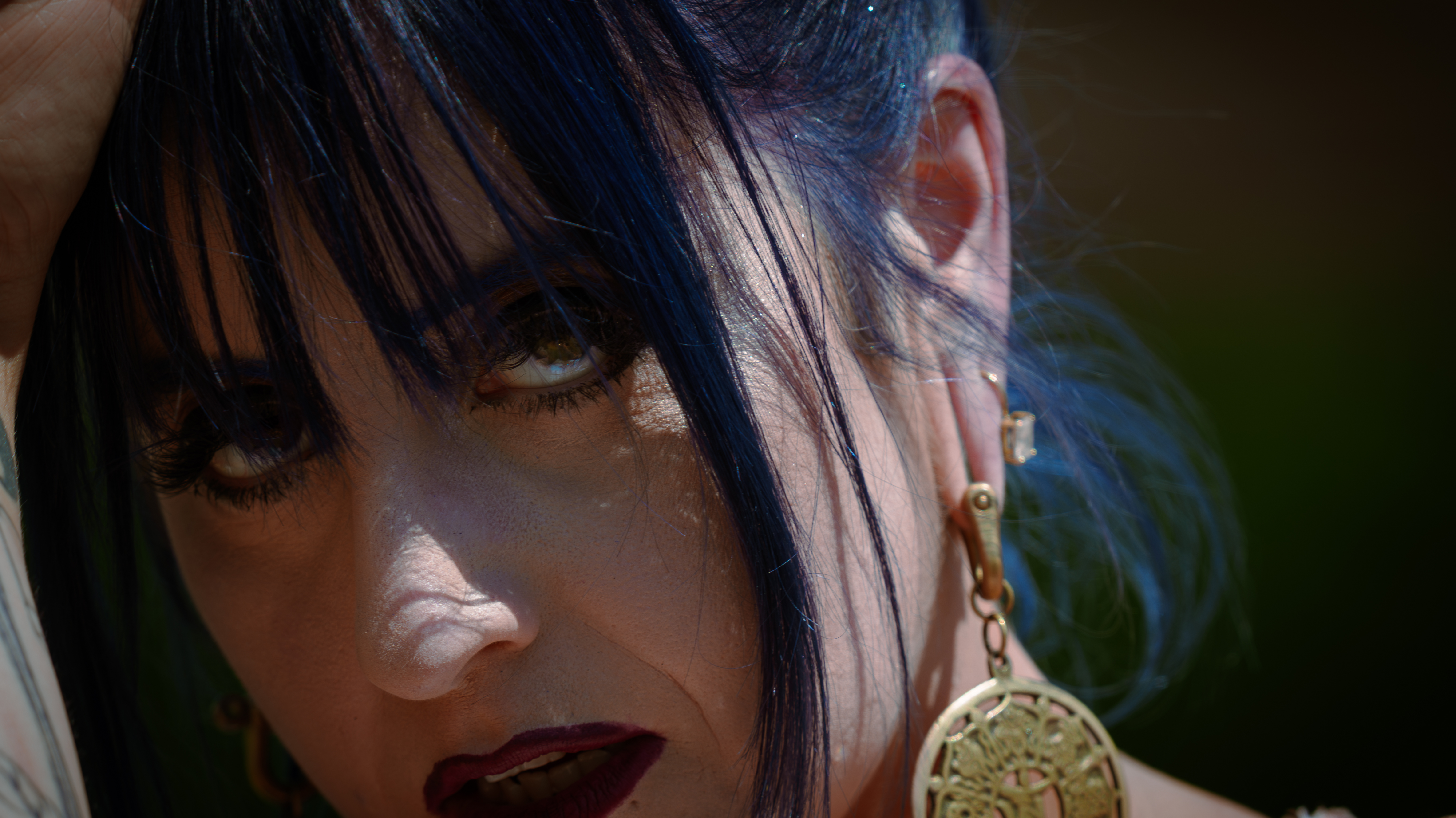 Woman with blue hair stareing deeply into the camera